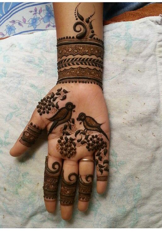 elegant birds and swirls mehndi design on front hand for girls