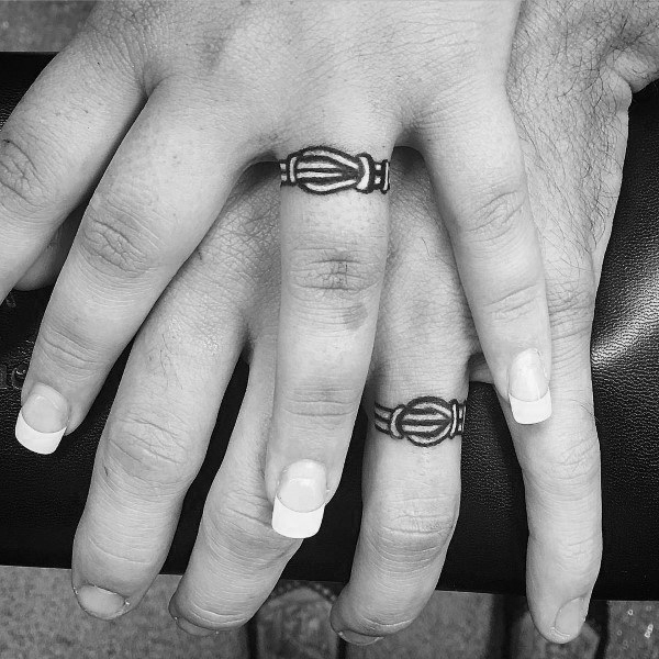couples matching knot tattoo on ring finger for marriage