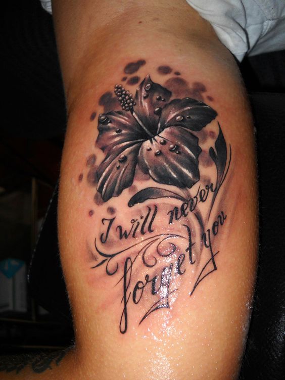 hibiscus flower with quote tattoo on men bicep