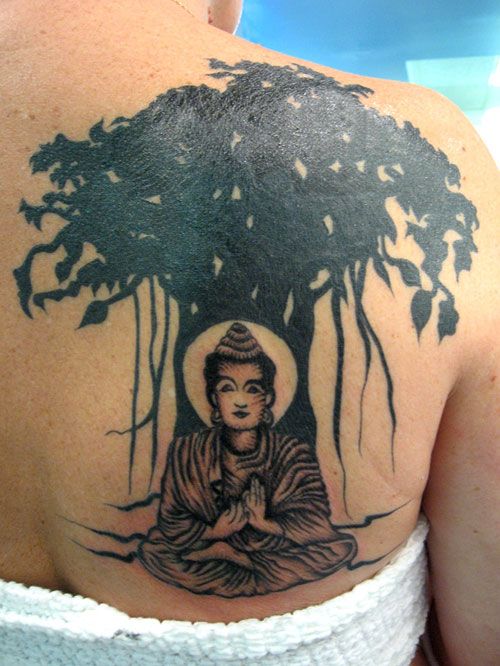realistic bodha sitting under bodhi tree tattoo