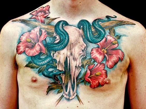 snake with skull and hawaiian Flowers tattoo on chest for men