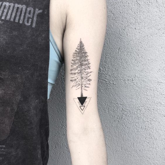 geometric pine tree tattoo design on bicep