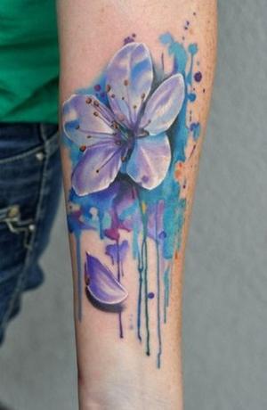 watercolor daisy flower tattoo design on forearm