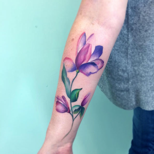 watercolor flower tattoo design on forearm