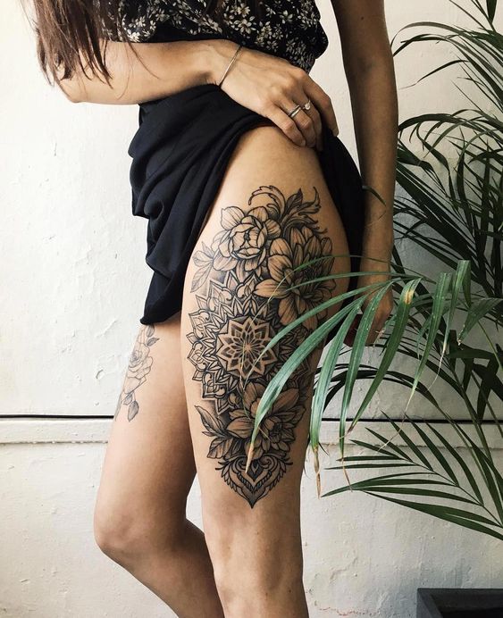 gorgeous mandala tattoo design with flowers on side thigh for females