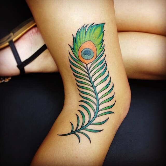 peacock feather tattoo on side knee