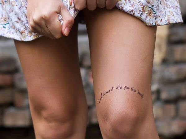 short quote tattoo above knee cap for girls