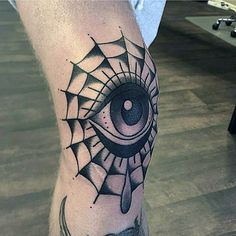 spider web with eye tattoo on knee