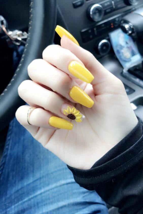 yellow acrylic coffin nails with sunflower design on one finger