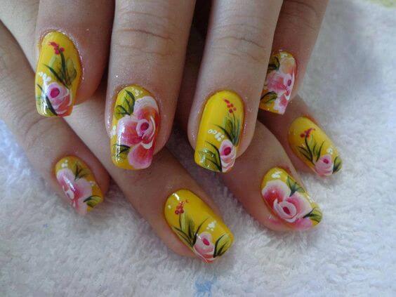 yellow nails with pink flowers