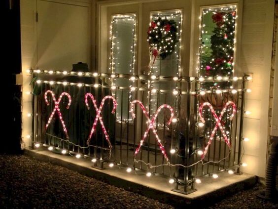 decorate a balcony with christmas candy canes and lights