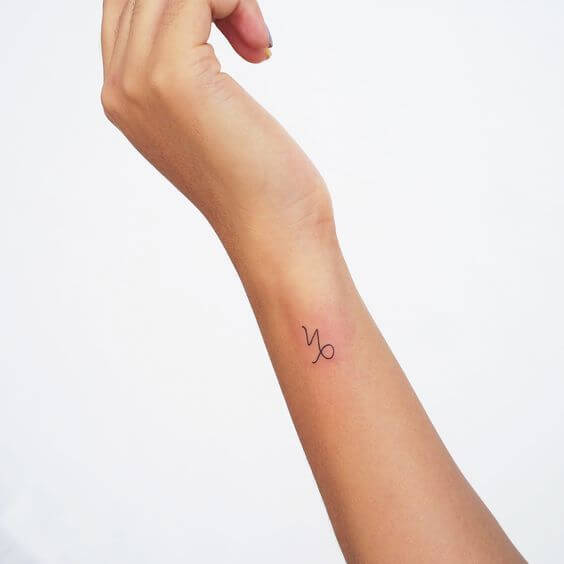 small capricorn symbol on side wrist