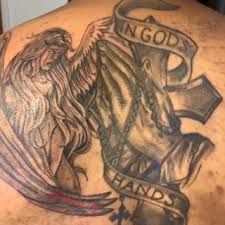 angel with in gods hands banner tattoo design and praying hands-rosary-cross on back