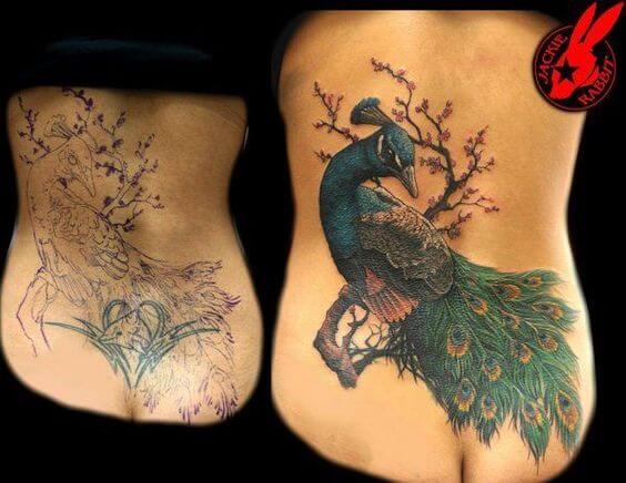 beautiful lower back peacock cover up tattoo design