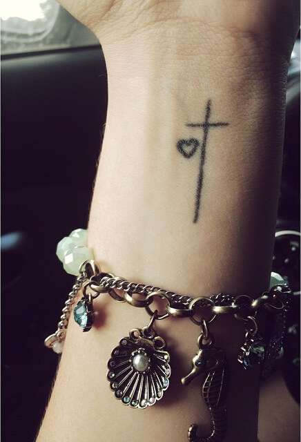 cross and heart tattoo on wrist