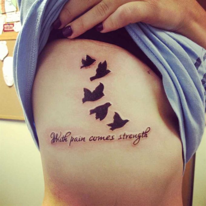 flying birds and with pain comes strength tattoo on ribs