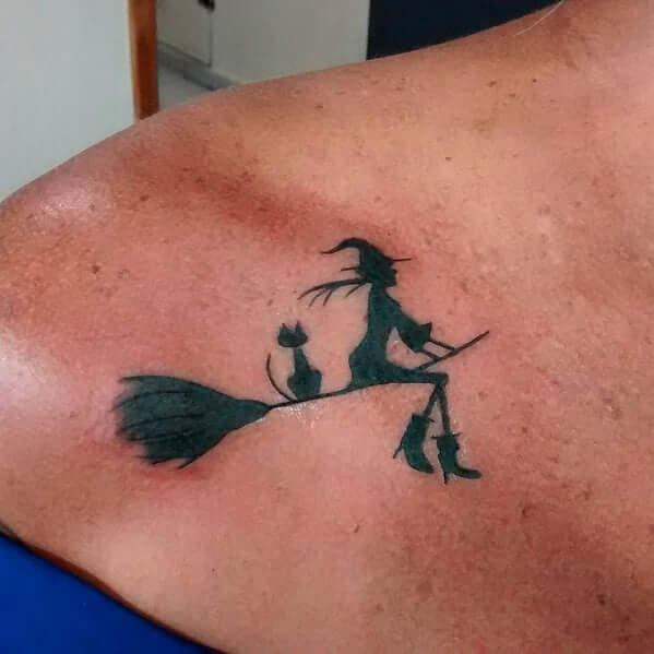 spooky cat with witch on broomstick small tattoo ideas for halloween
