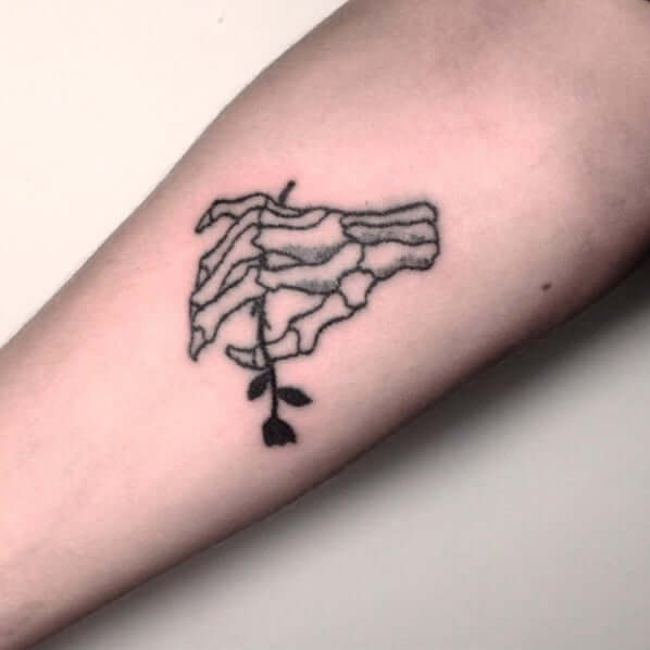 skull hand with black rose tattoo for halloween