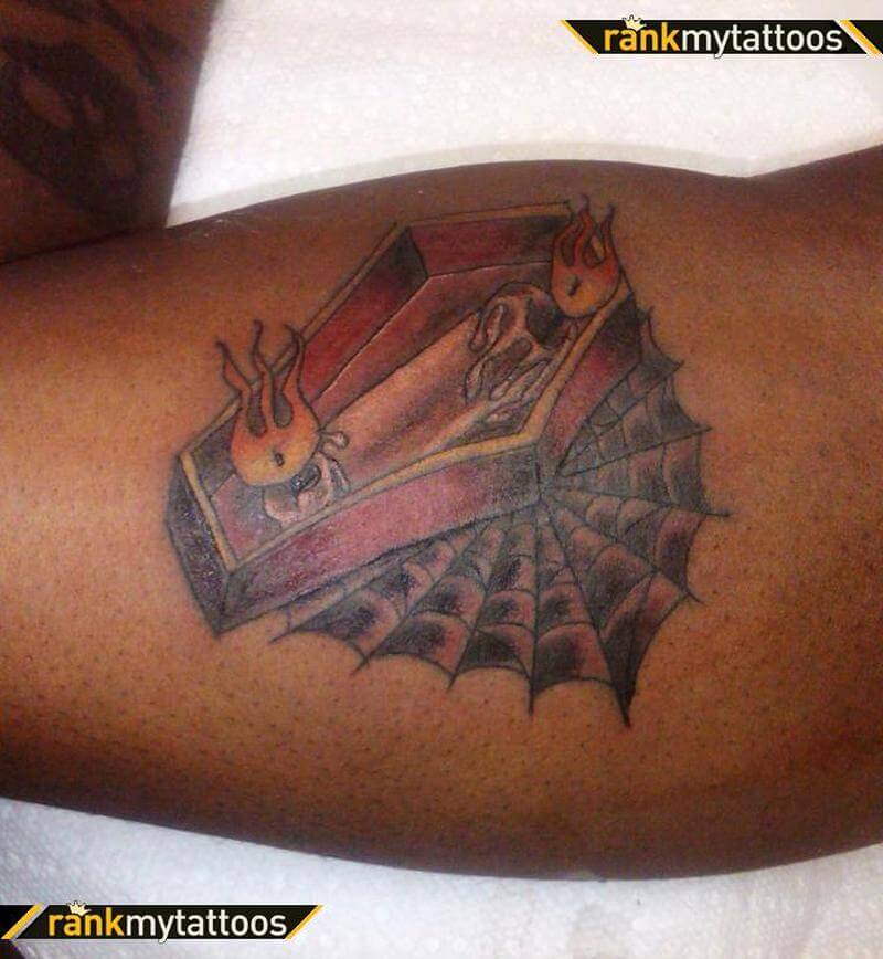 small spider web tattoo on arm